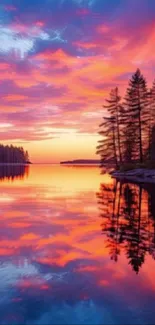 Vibrant sunset reflecting on a tranquil lake with silhouetted trees.