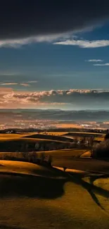 Dramatic sunset over rolling hills landscape wallpaper.