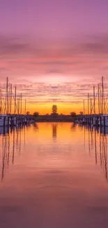 Vibrant sunset over marina with reflections.