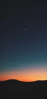 Serene sunset with crescent moon and gradient sky over a dark landscape.