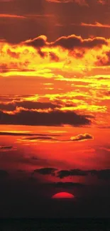 Vibrant sunset over ocean horizon with glowing orange sky.