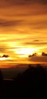 Orange sunset sky with clouds and silhouette.