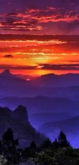 Vibrant sunset over a mountain landscape with purple hues.