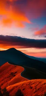 Captivating sunset over a mountain with vibrant orange hues and winding road.