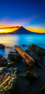 Breathtaking sunset view over mountain with ocean and rocky shore.