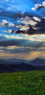 Sunset over mountains with dramatic clouds and colorful sky.