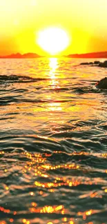 Vibrant sunset over ocean with golden reflections on water.