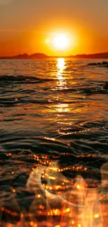 Vibrant sunset over ocean waves with glowing reflections.