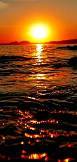 Breathtaking sunset over a rippling ocean with warm, glowing colors.