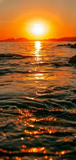 Beautiful sunset over ocean with orange reflections on the water.