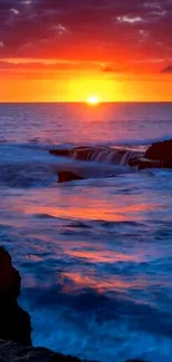 Stunning sunset over ocean with vivid skies and waves.