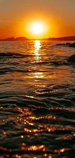 Beautiful sunset over ocean with golden reflections on water.