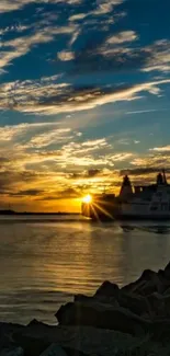 Serene sunset over ocean with ship silhouette and dramatic sky.