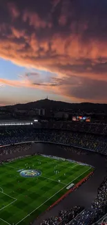 Aerial view of a football stadium beneath a stunning orange sunset.