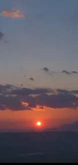 Breathtaking sunset over dusky mountains with a vivid, colorful sky.