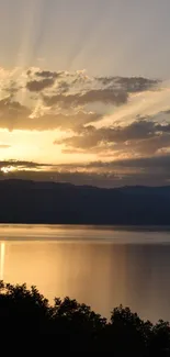 Stunning sunset over a tranquil lake with calm, reflective waters and a colorful sky.