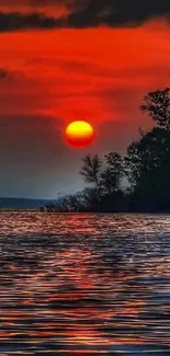 Stunning red and orange sunset over calm water.