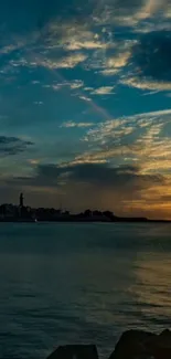 Sunset over ocean with vibrant sky and calm waters.