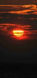 Captivating sunset with orange hues and dark clouds.