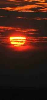 Fiery sunset over calm ocean horizon.