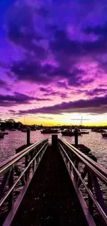 Purple sunset over pier with boats.