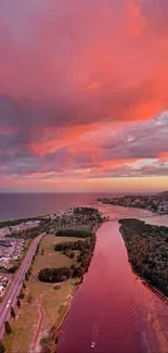 Aerial view of sunset over a river with pink and orange sky.