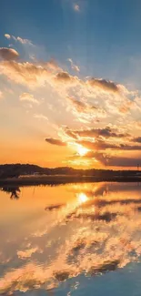 Serene sunset with reflections over calm water under a vibrant sky.