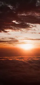 Sunset over clouds with a vibrant orange sky.