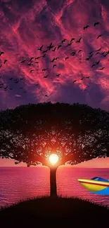 Vibrant sunset scene with tree silhouette.