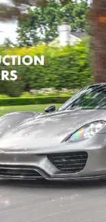 Silver supercar speeding down a tree-lined street.