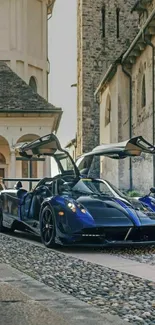 Supercar parked on cobblestone street by heritage building.