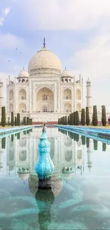 Majestic Taj Mahal with reflection in water under a blue sky.