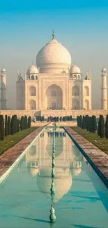 Stunning view of the Taj Mahal reflecting in a serene pool under a blue sky.