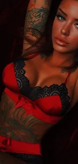 Tattooed woman in red lingerie with bold backdrop.