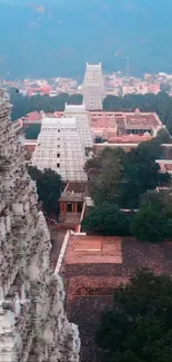 Aerial view of a stunning temple surrounded by lush greenery and intricate architecture.