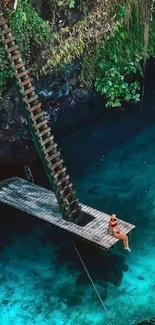 Woman on a wooden platform over a tropical turquoise lagoon.