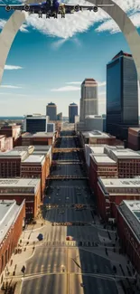 Urban skyline with arch and airplane overhead.