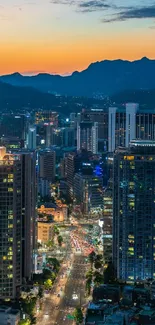 Vibrant city skyline at dusk with sunset.