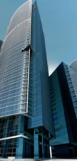 Tall modern skyscrapers under a clear blue sky, showcasing urban architecture.