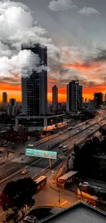 A stunning urban skyline with orange sunset and dramatic clouds.