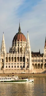 Budapest Parliament Building reflecting on Danube River at sunset.