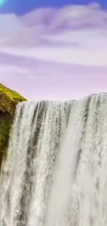 Mobile wallpaper of a waterfall with a rainbow and lush greenery.