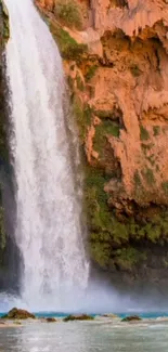 Majestic waterfall in canyon with lush greenery, perfect serene wallpaper.