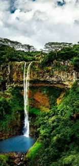 Waterfall in lush forest with dramatic sky.