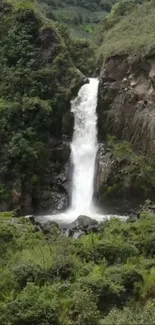 Beautiful waterfall surrounded by lush greenery and rocky cliffs.