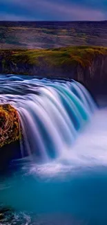 Stunning blue waterfall with lush green backdrop, perfect mobile wallpaper.