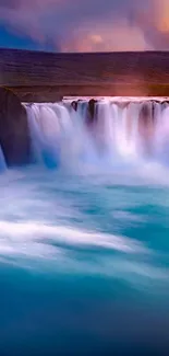 Majestic waterfall with vibrant blue waters at sunset for mobile wallpaper.