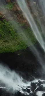 Waterfall cascading over lush green cliff, serene wallpaper.