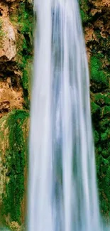 Majestic waterfall cascading down lush green cliffs.