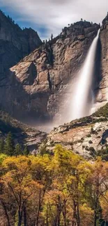 Breathtaking waterfall cascading down cliffs with vibrant foreground foliage.